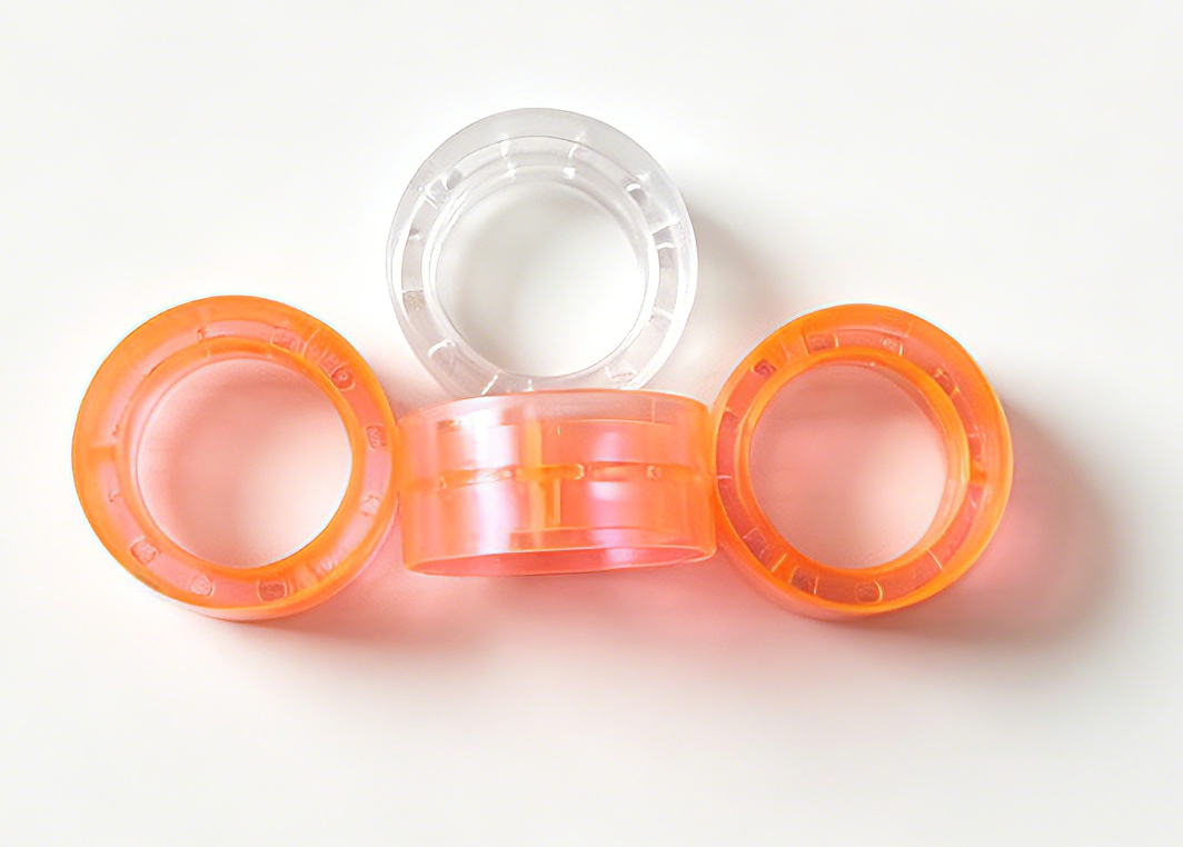 Super clear colored plastic tape cores for stationery tape rolls, orange and clear translucent plastic spools